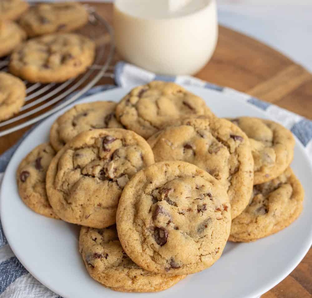 a plate stacked with chocolate chip cookies