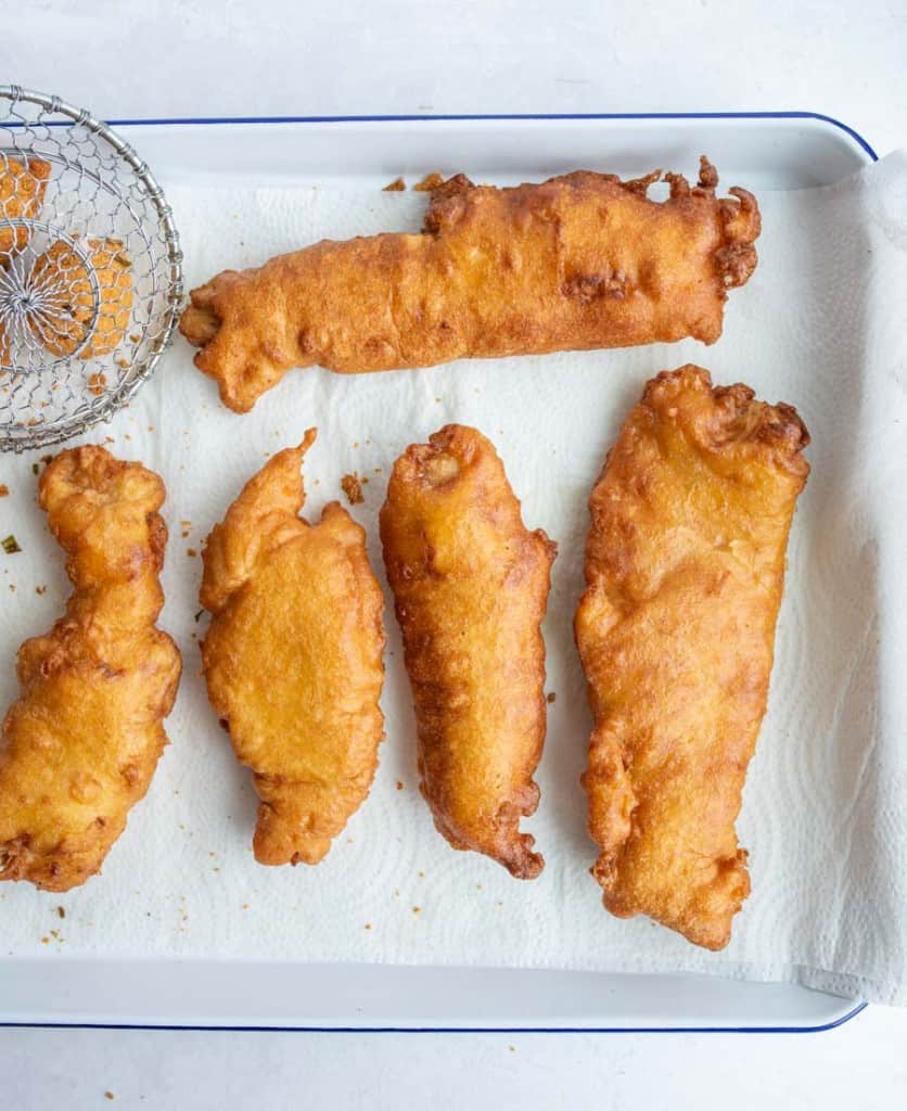 crispy golden deep fried and beer batter fish on a baking dish