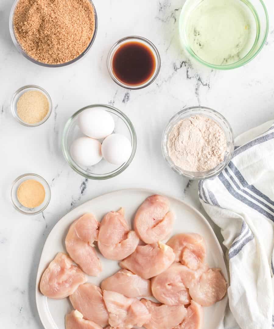 all ingredients for homemade chicken nuggets in small clear bowls