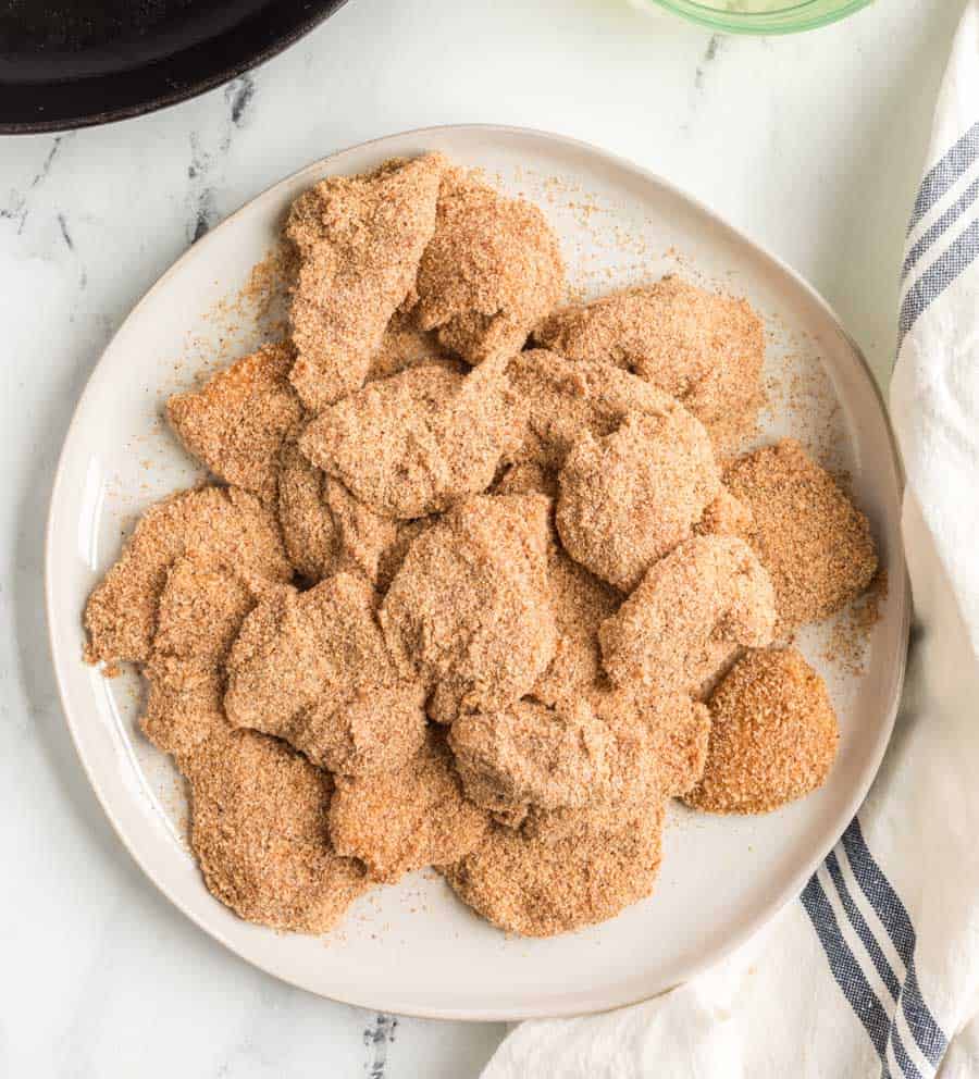 freshly breaded but raw homemade chicken nuggets waiting to be fried.