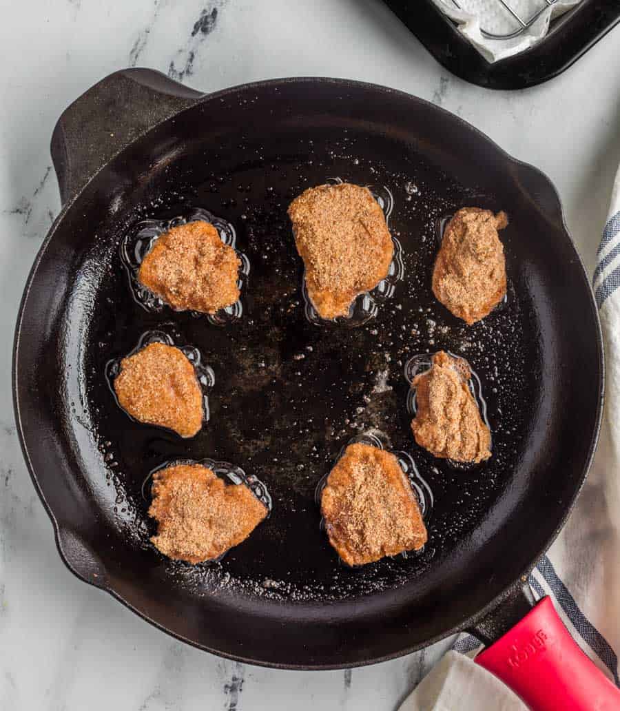 pan with oil and top view of cooking nuggets in the pan.