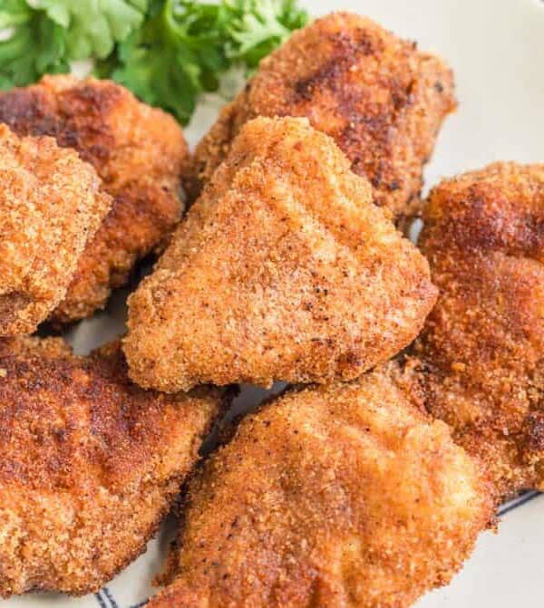 close up of crispy fried and golden homemade chicken nuggets.