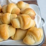 small shiny buttered rolls in a rolled up croissant shape