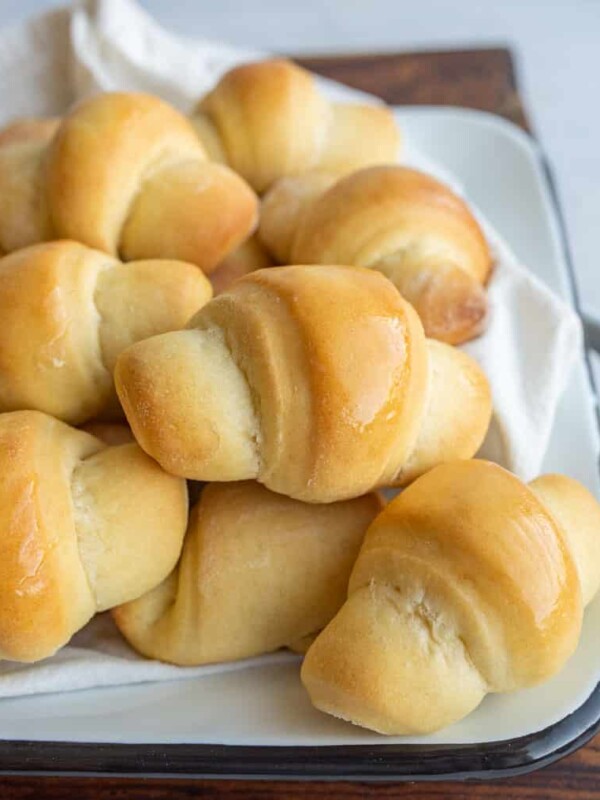 small shiny buttered rolls in a rolled up croissant shape
