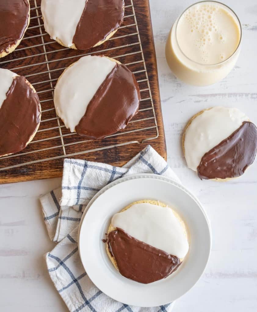 black and white iced cookies exactly half and half split of each color on a cooling rack