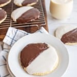 black and white iced cookies exactly half and half split of each color on a cooling rack