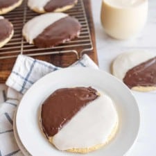 black and white iced cookies exactly half and half split of each color on a cooling rack