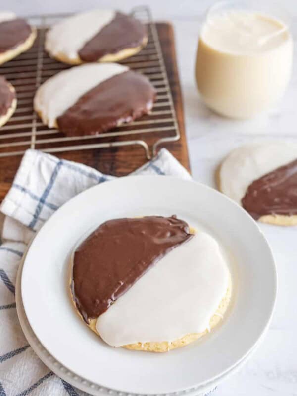 black and white iced cookies exactly half and half split of each color on a cooling rack