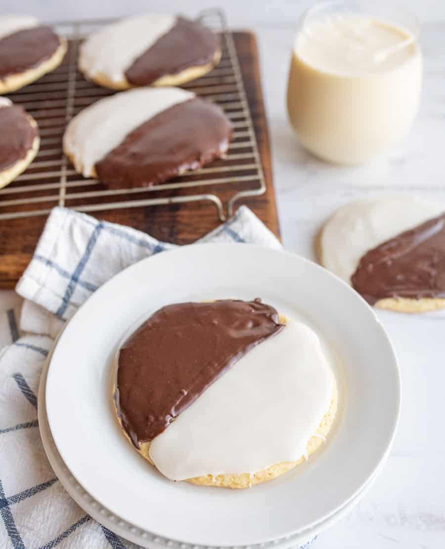 black and white iced cookies exactly half and half split of each color on a cooling rack