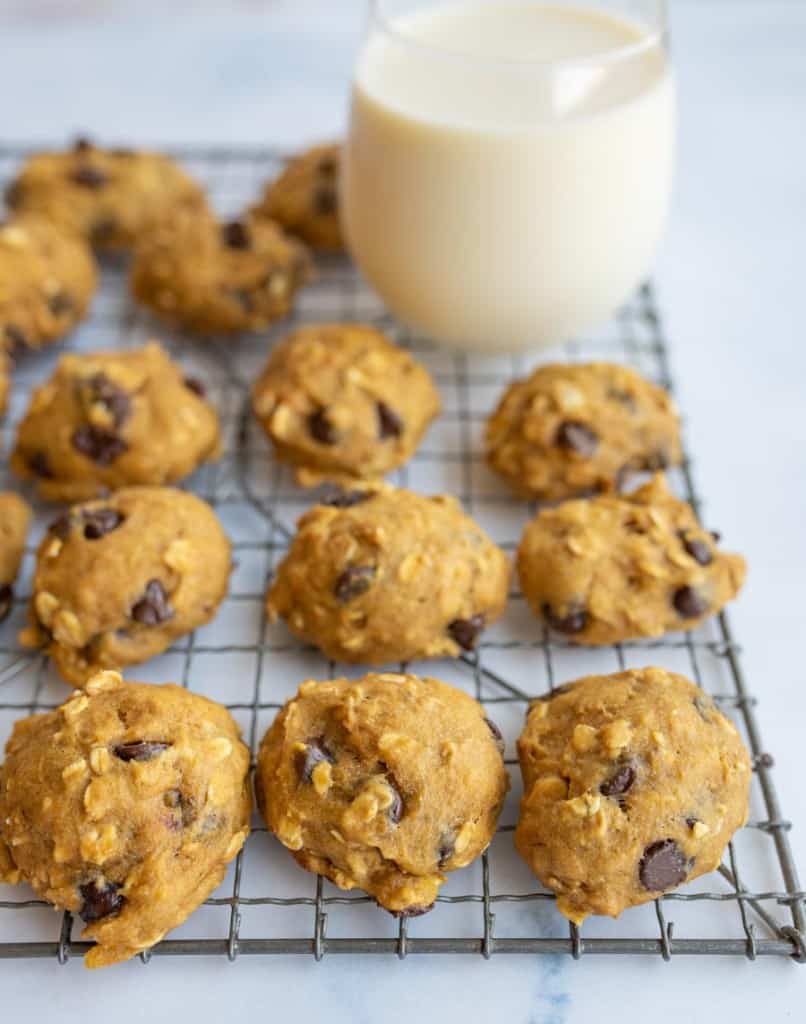 breakfast cookies on a cooling rack and a glass of milk