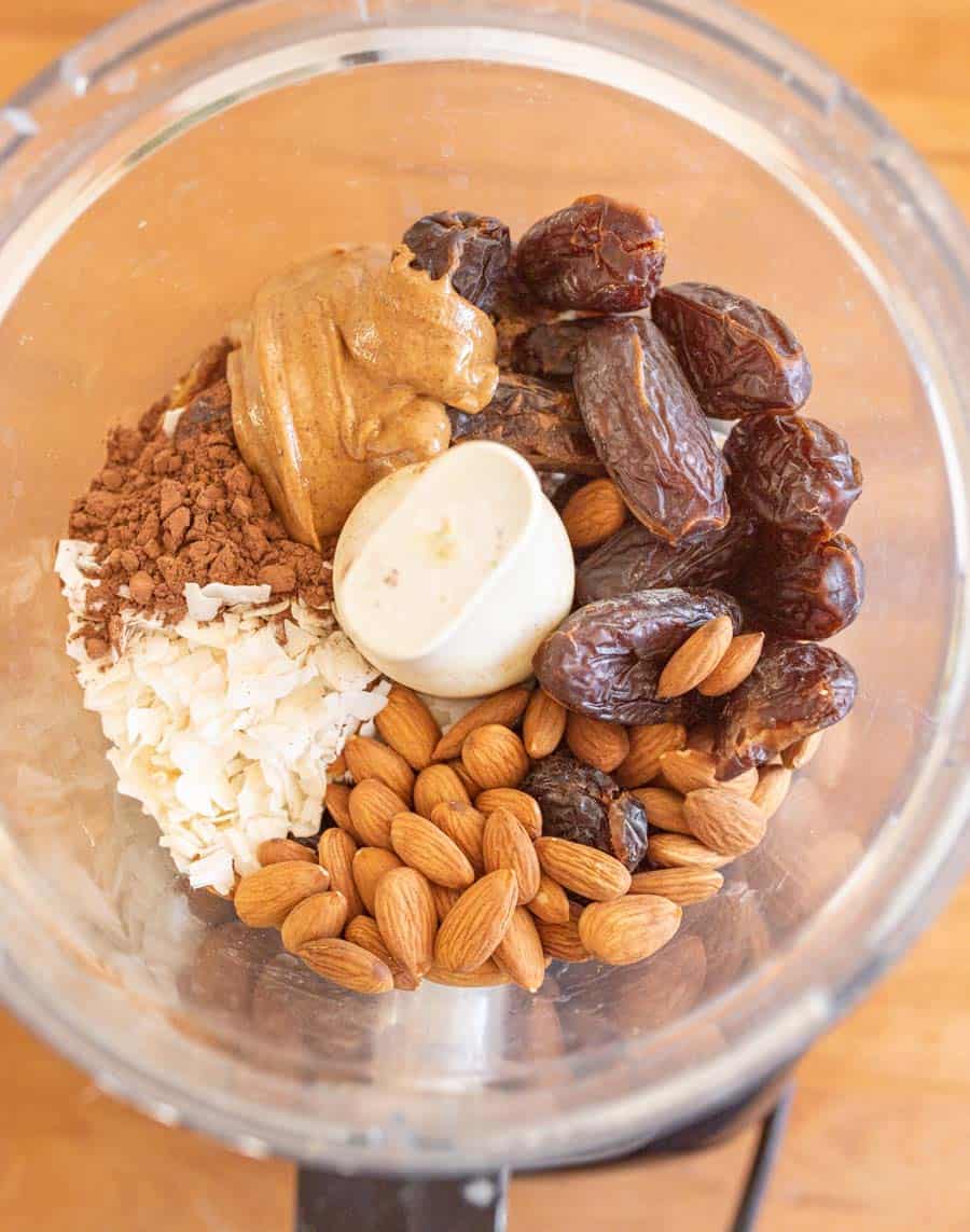 dates peanut butter coconut and nuts in a food processor ready to make the healthy snack bars