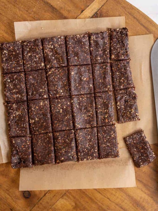 cutting squares out of the healthy date and nut snack bars on parchment