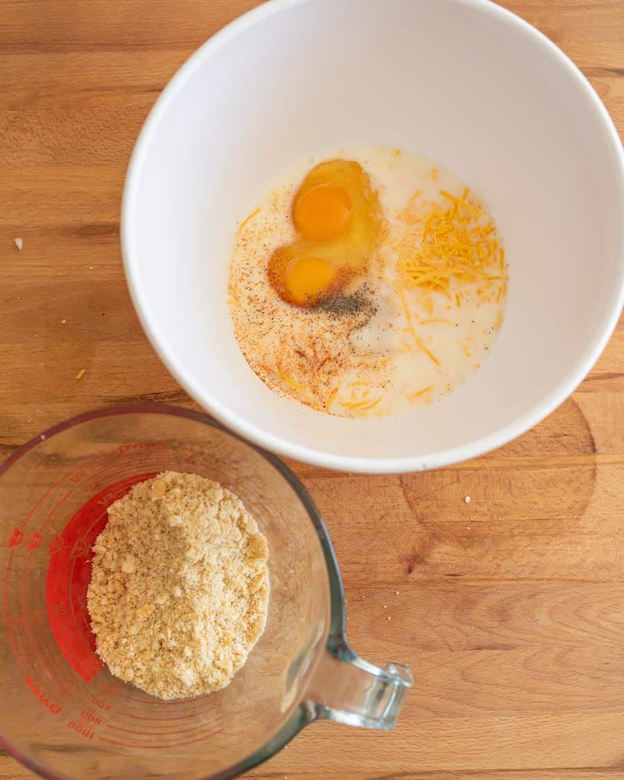 ingredients in a white mixing bowl and a pyrex measuring cup