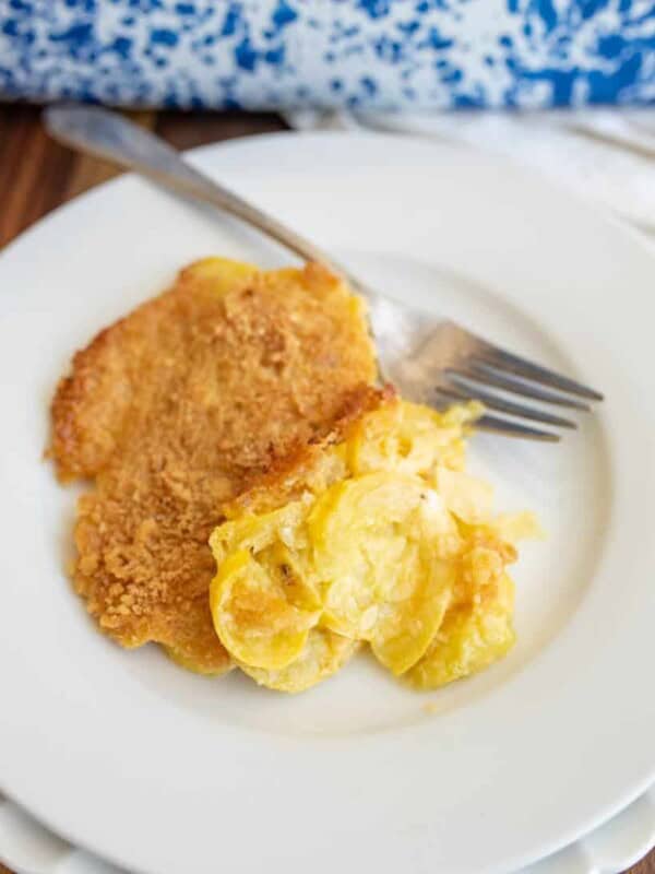 squash casserole with a crispy top dished onto a plate