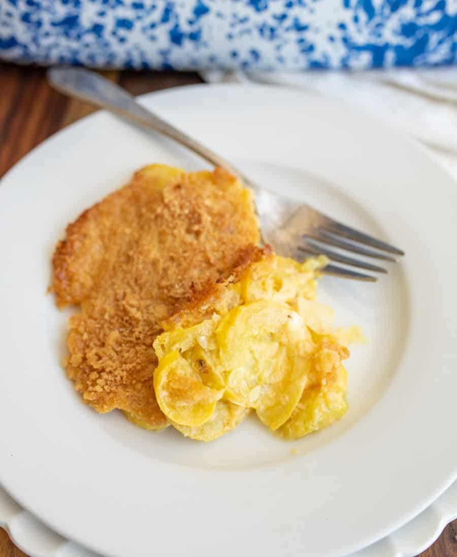 squash casserole with a crispy top dished onto a plate