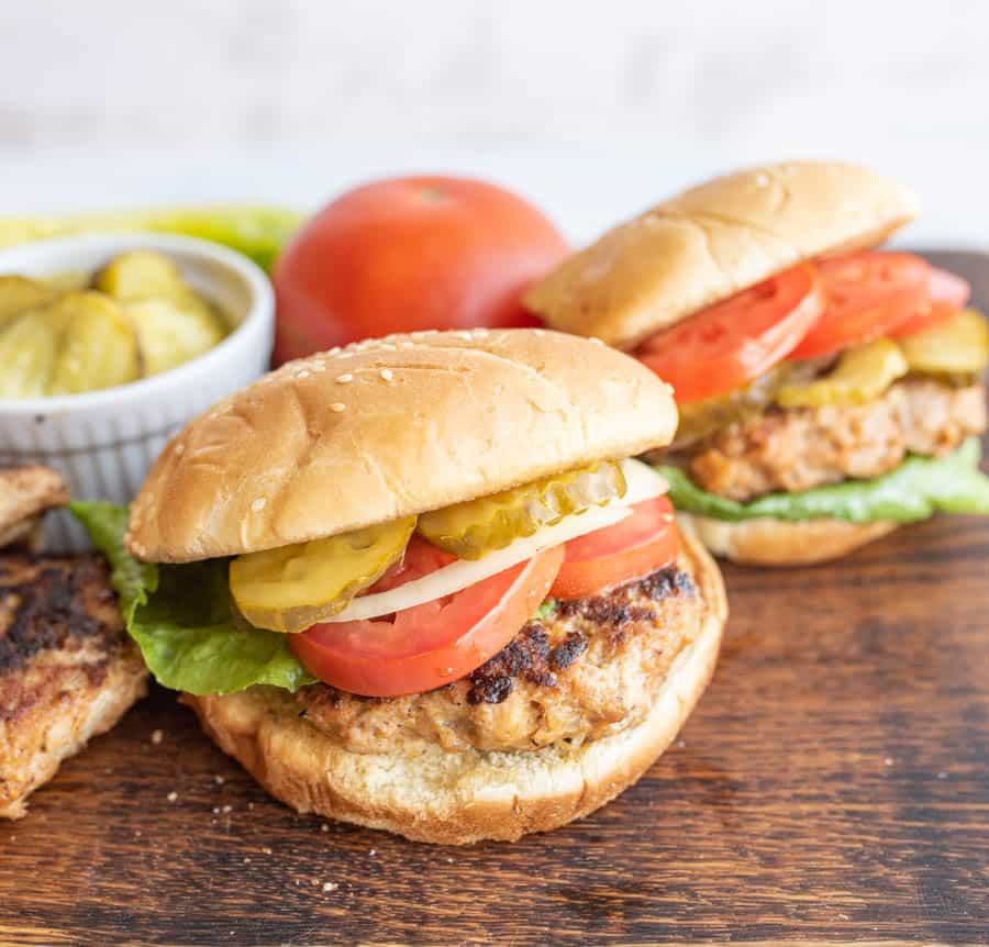 fully assembled turkey burgers on a cutting board