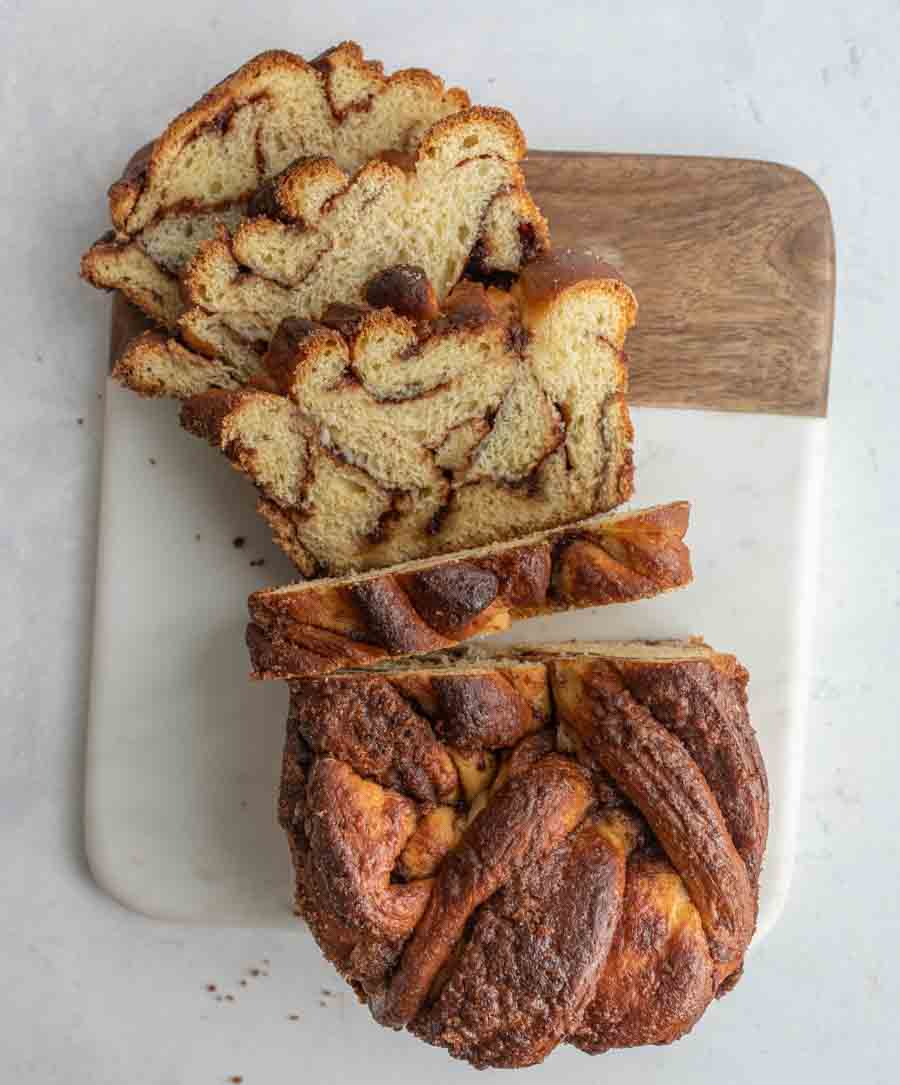 top view of a sliced loaf of cinnamon bread sliced half way