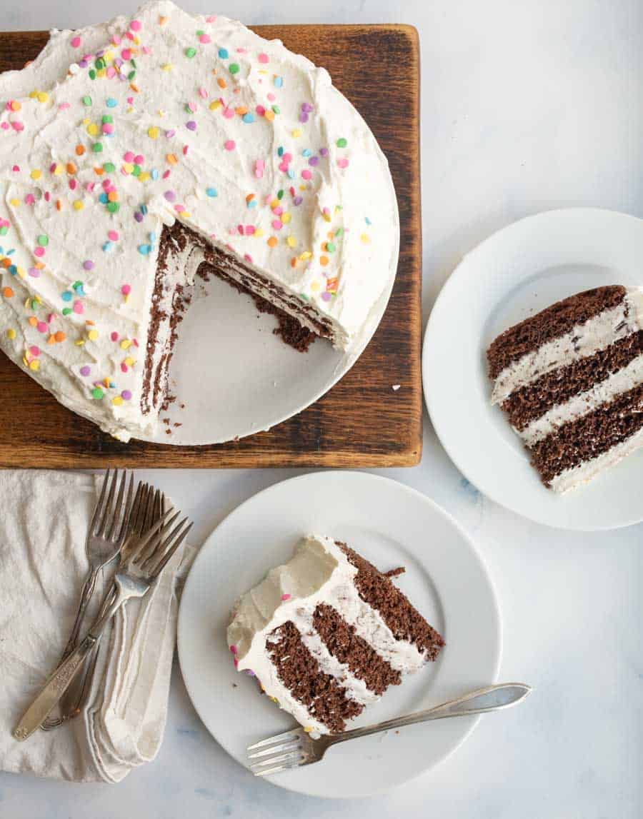 top view of ice cream cake, with the slices taken out on white plates in front of it