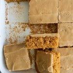 slices of pumpkin cake in a sheet pan with a caramel icing on top