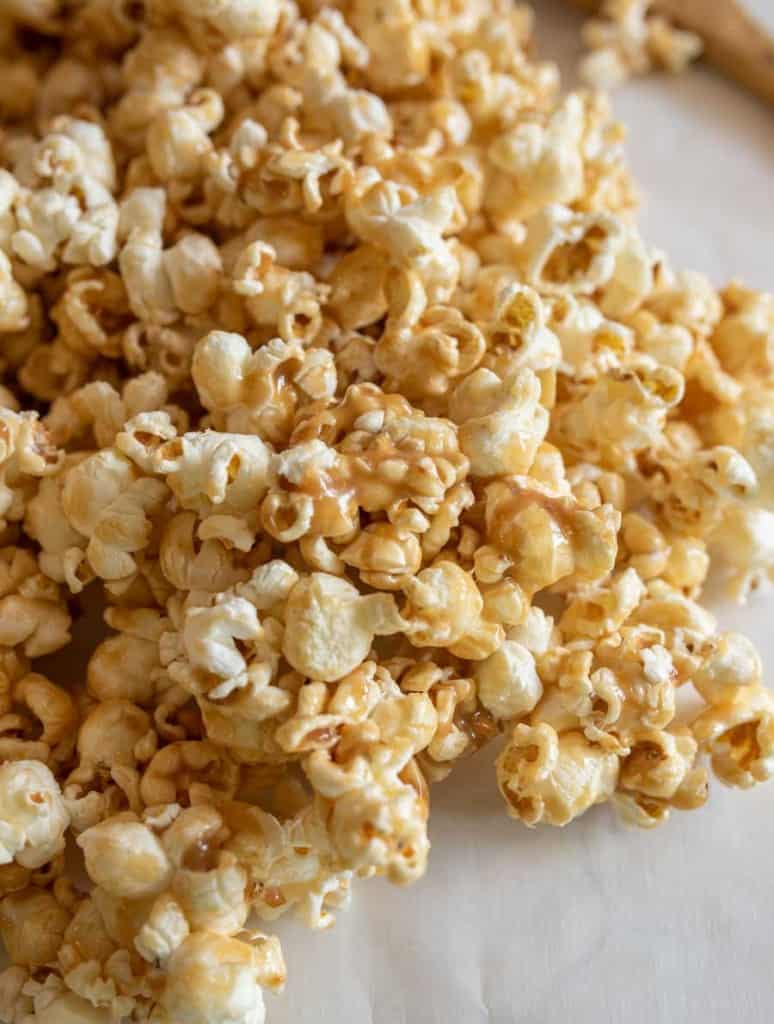 close up of soft caramel popcorn on a big white and blue bowl