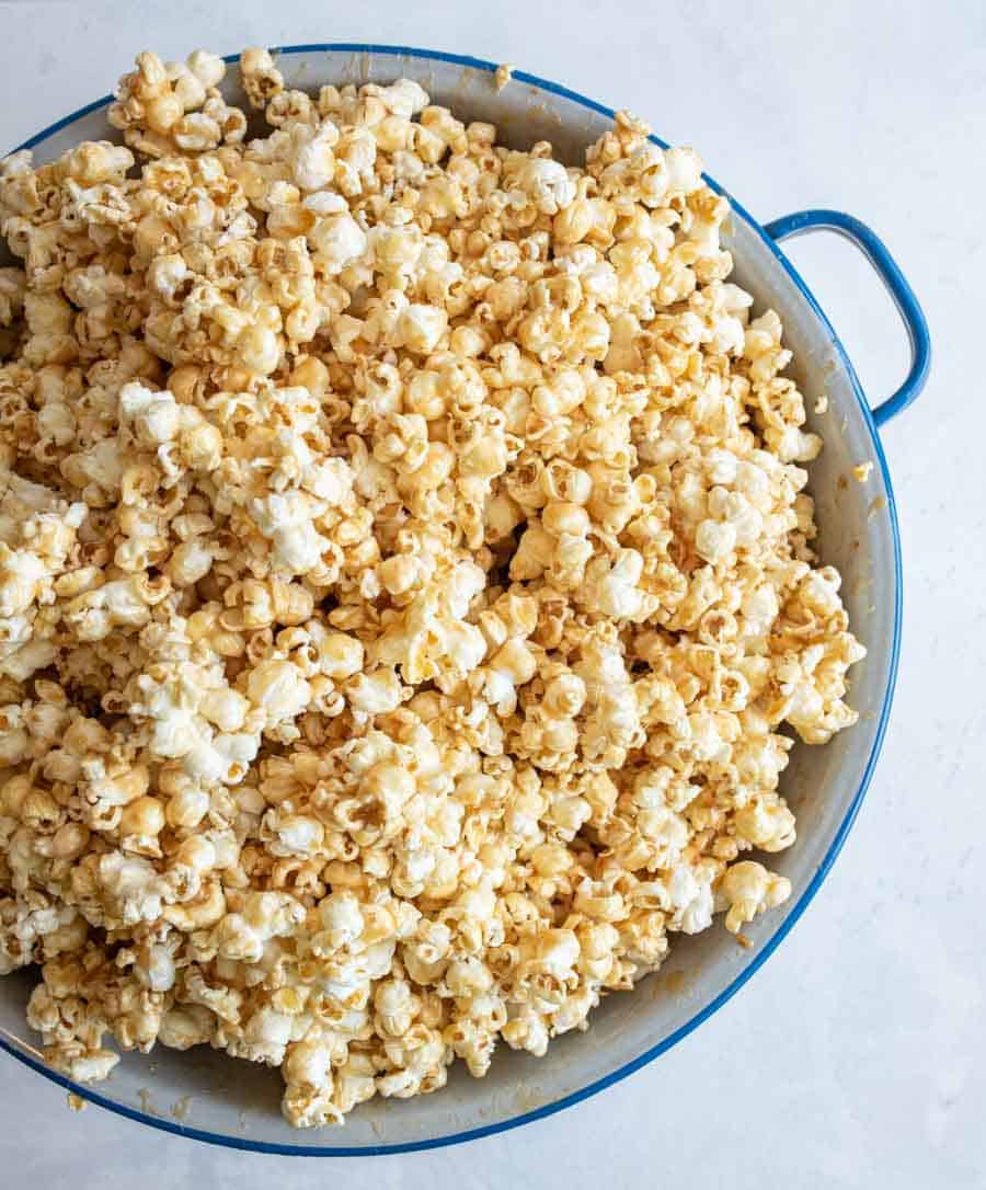 top view of soft caramel popcorn on a big white and blue bowl