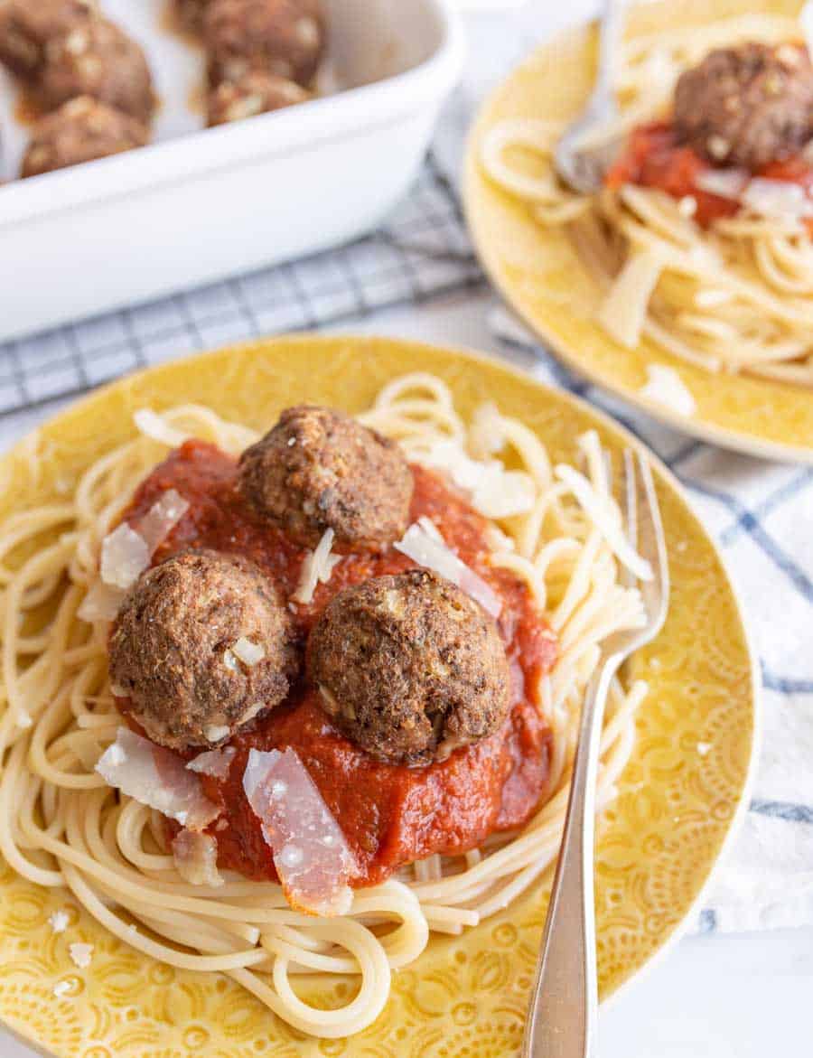 yellow plate of spaghetti with turkey meatballs on top