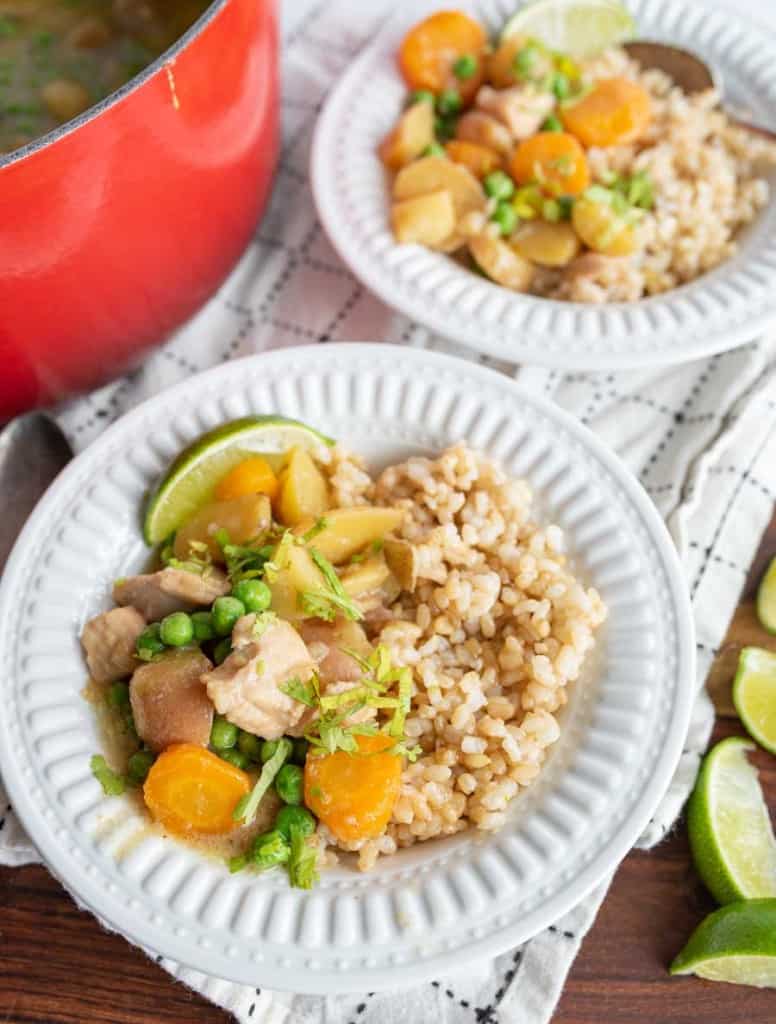green curry over rice in white bowls