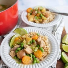 green curry over rice in white bowls