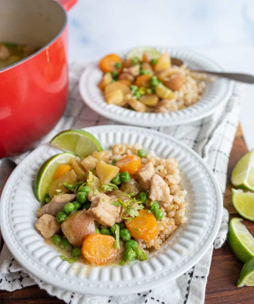 green curry over rice in white bowls