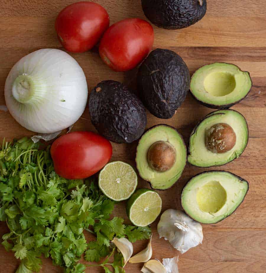 top view of veggies and avocado as the ingredients for guacamole