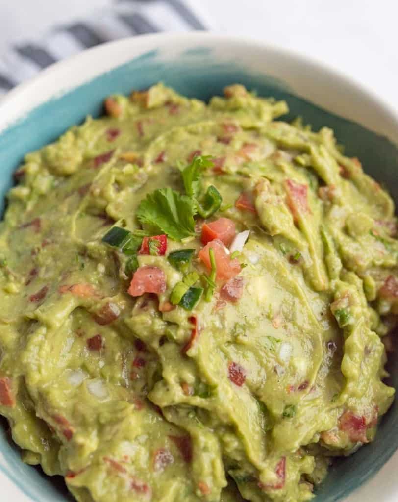 guacamole in a white and blue bowl