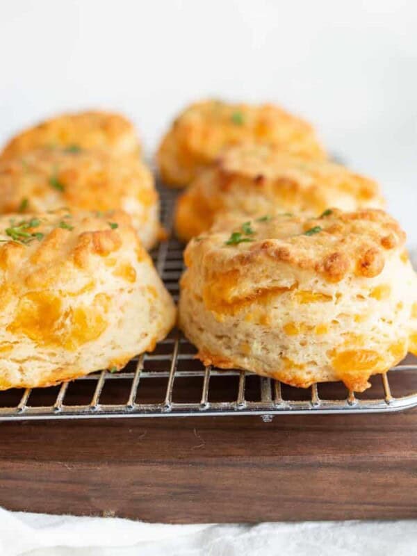 side view of cheddar biscuits on a cooling rack