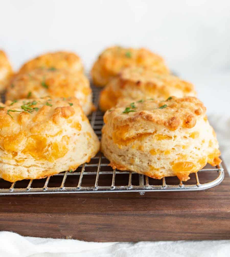side view of cheddar biscuits on a cooling rack