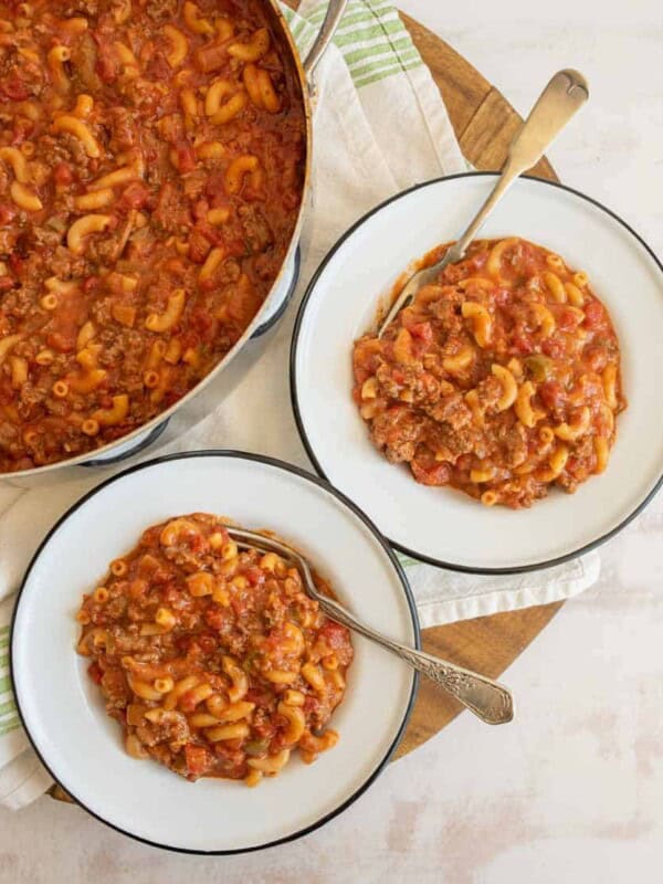 top view of two bowls of goulash and the whole pot next to it