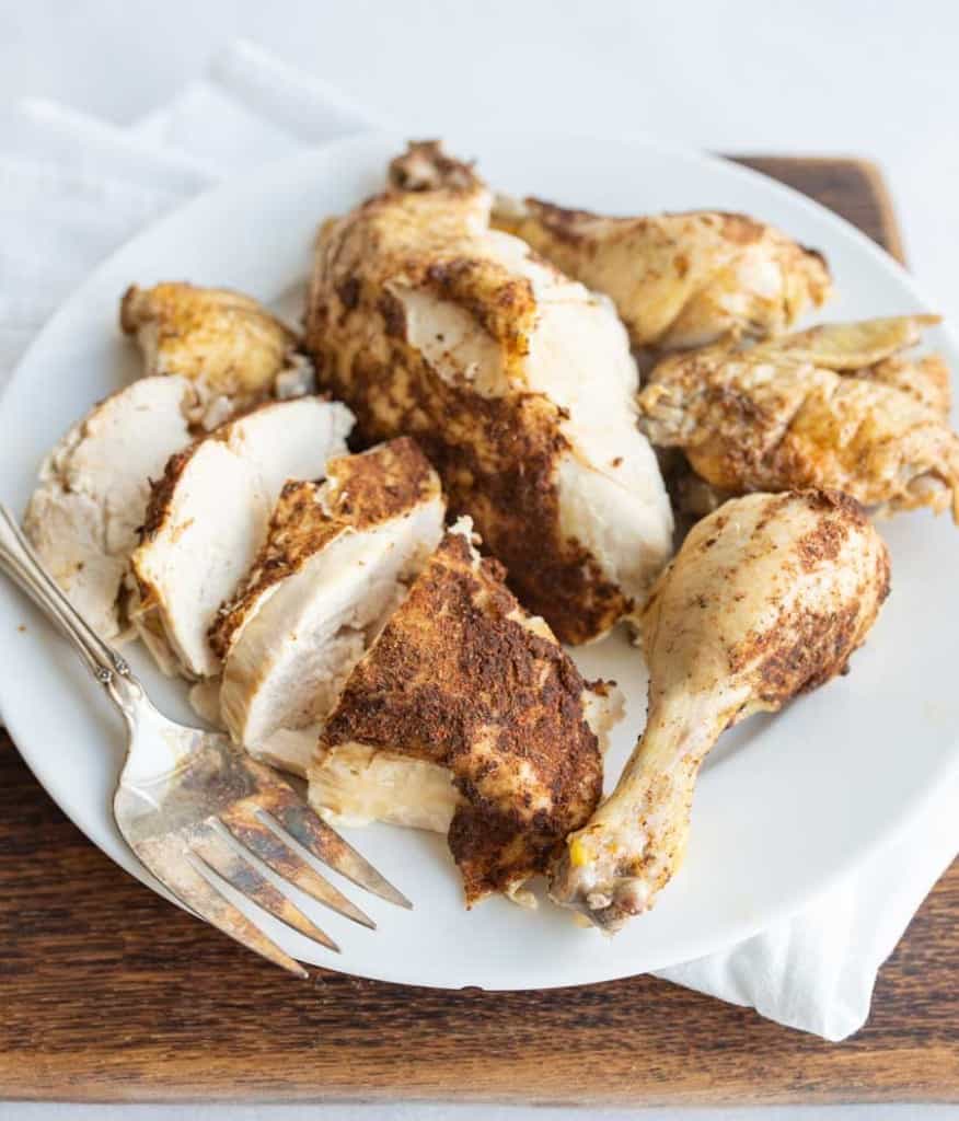 insta pot cooked chicken pieces cut up on a white plate