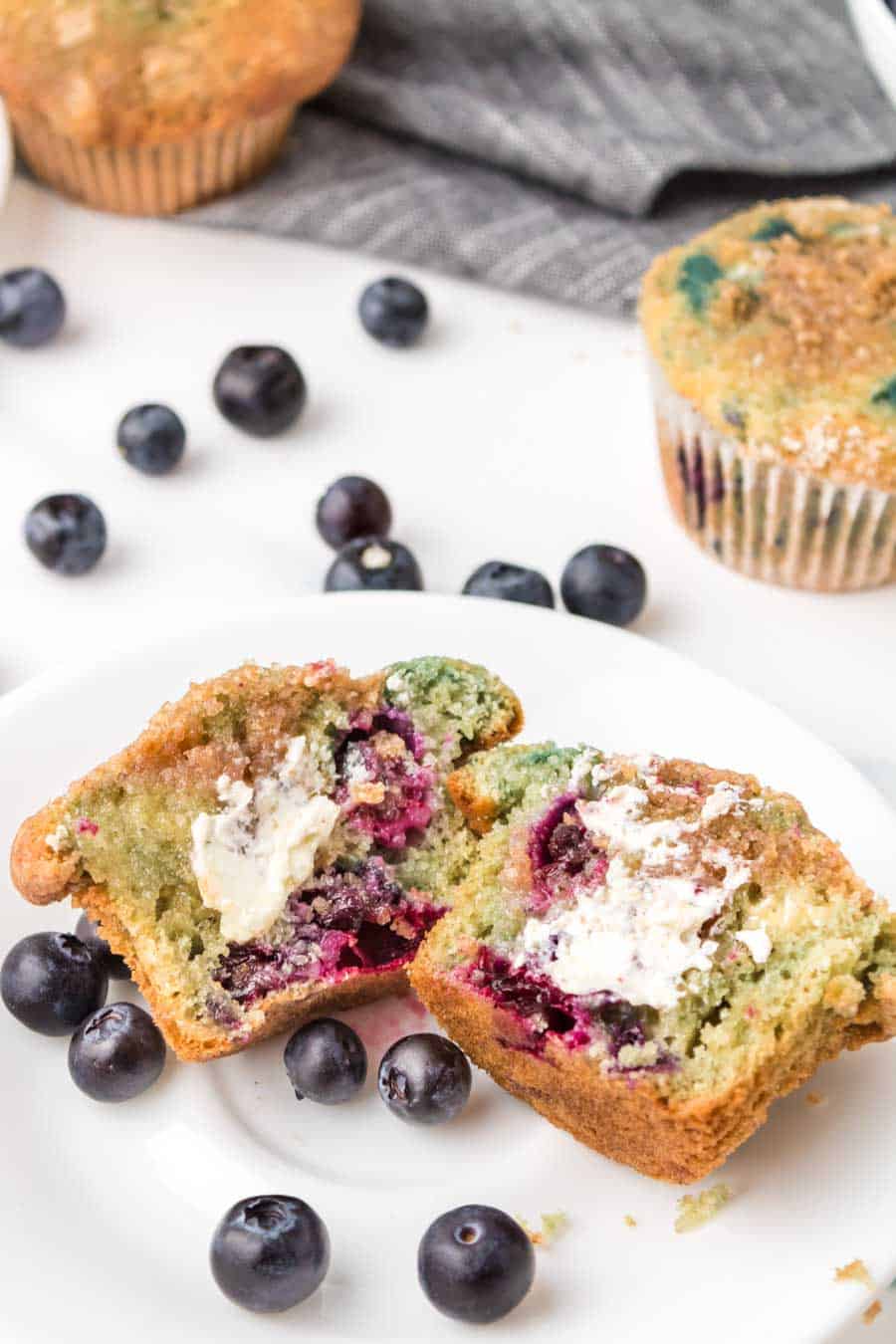 homemade blueberry muffin cut in half and buttered