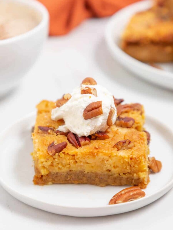 one square slice of a pumpkin dump cake with pecans on top