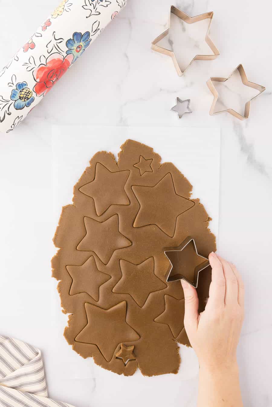 stars of gingerbread being cut with a cookie cutter
