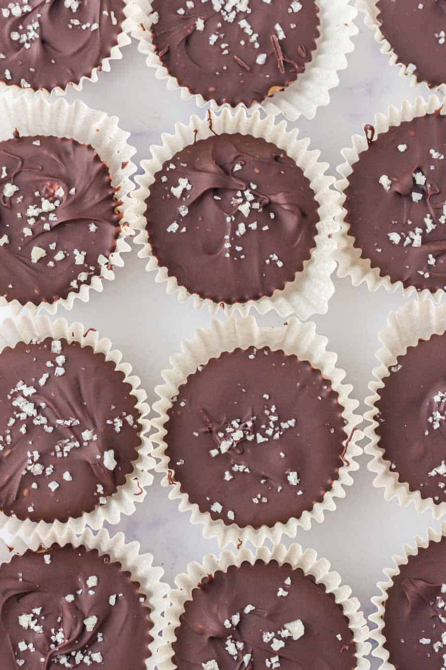 top view of homemade chocolate peanut butter cups in rows on a baking dish