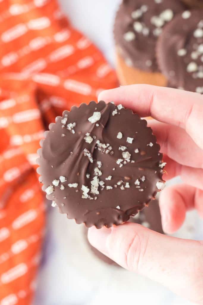 POV hand holding a homemade chocolate peanut butter cups.