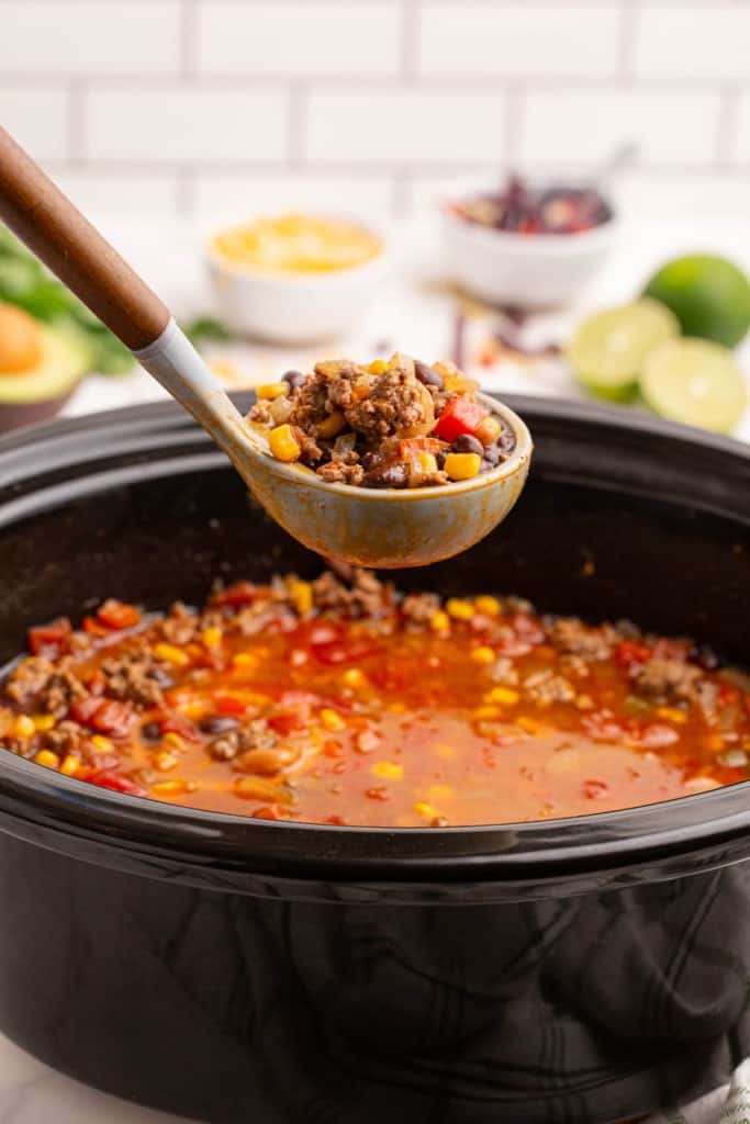 slow cooker and a ladle with taco soup