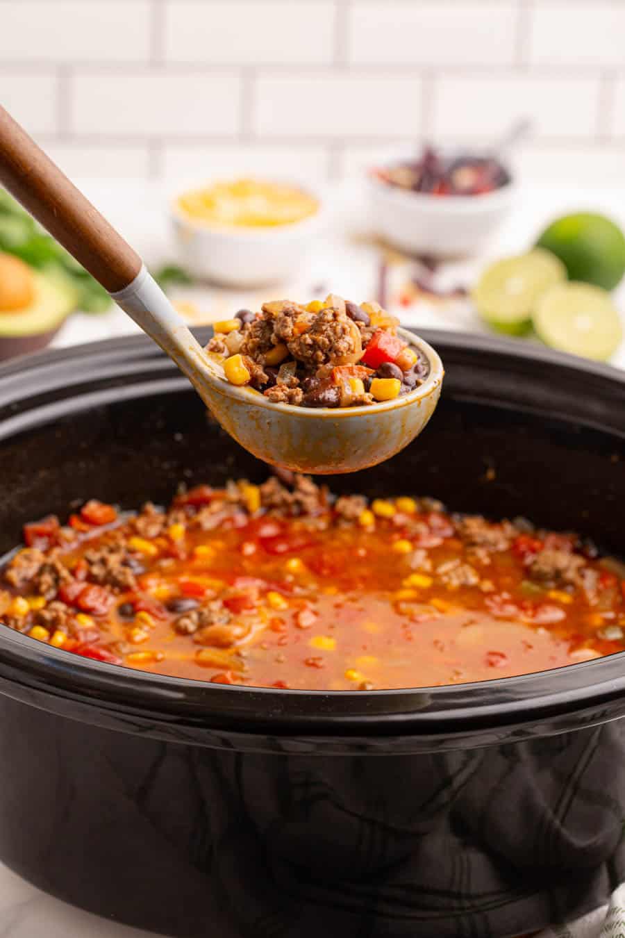 slow cooker and a ladle with taco soup