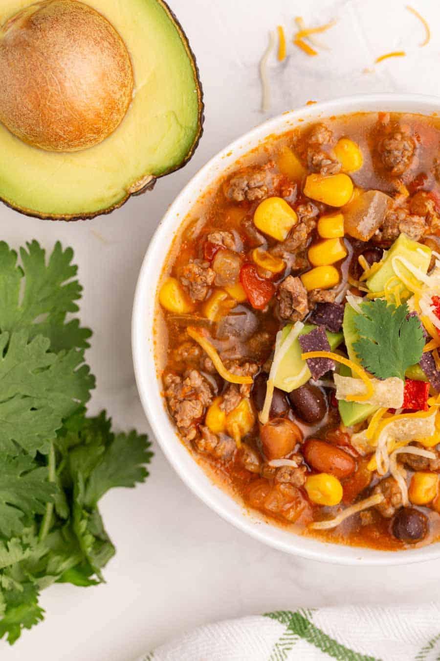 top view of slow cooker taco soup and an avocado