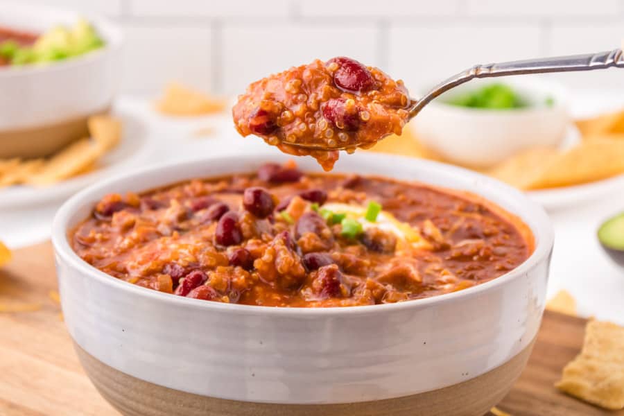 white bowl of vegetarian chili with a spoon