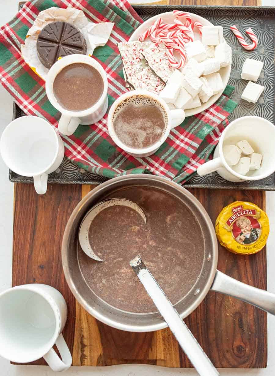 pot of Mexican hot chocolate and mugs