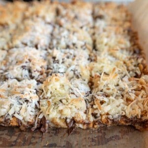 7 Layer Magic Bars being sliced from the whole baked sheet