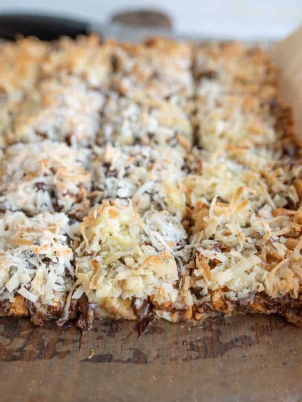 7 Layer Magic Bars being sliced from the whole baked sheet