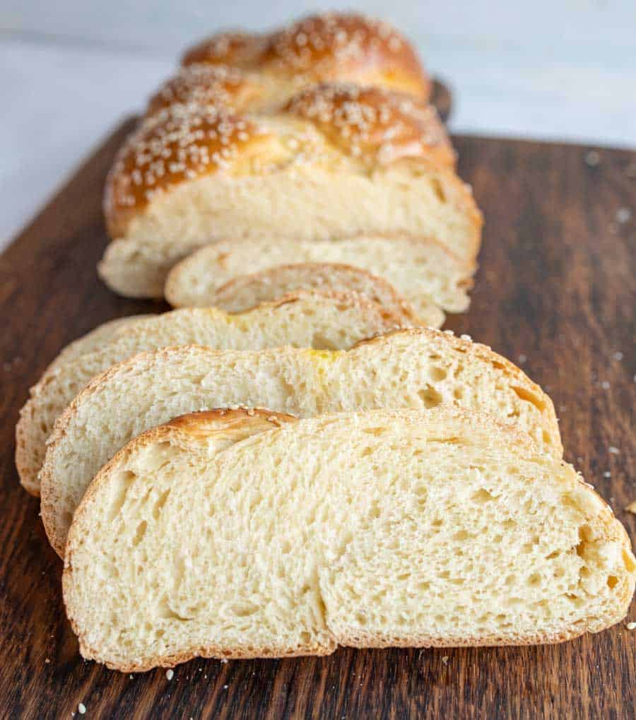 Sesame challah bread loaf half sliced close up