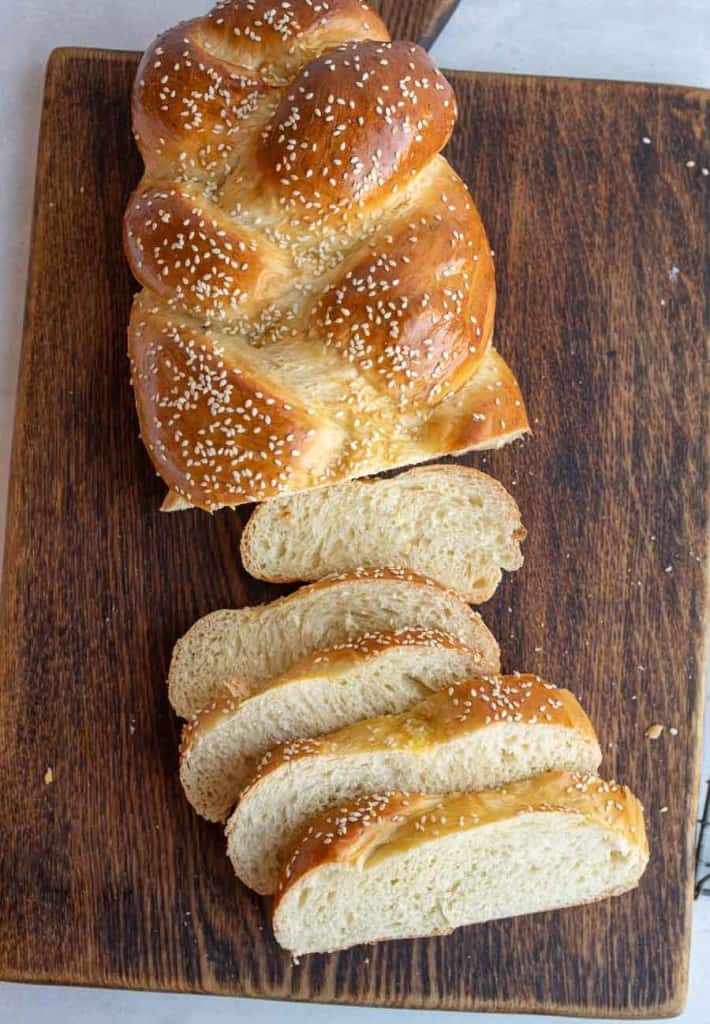 Sesame challah bread loaf half sliced