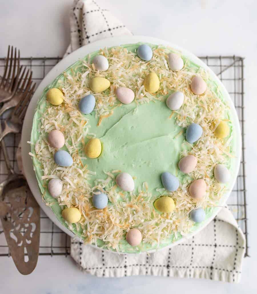 top view of whole decorated easter coconut cake and the coconut shreds make a nest for candy eggs
